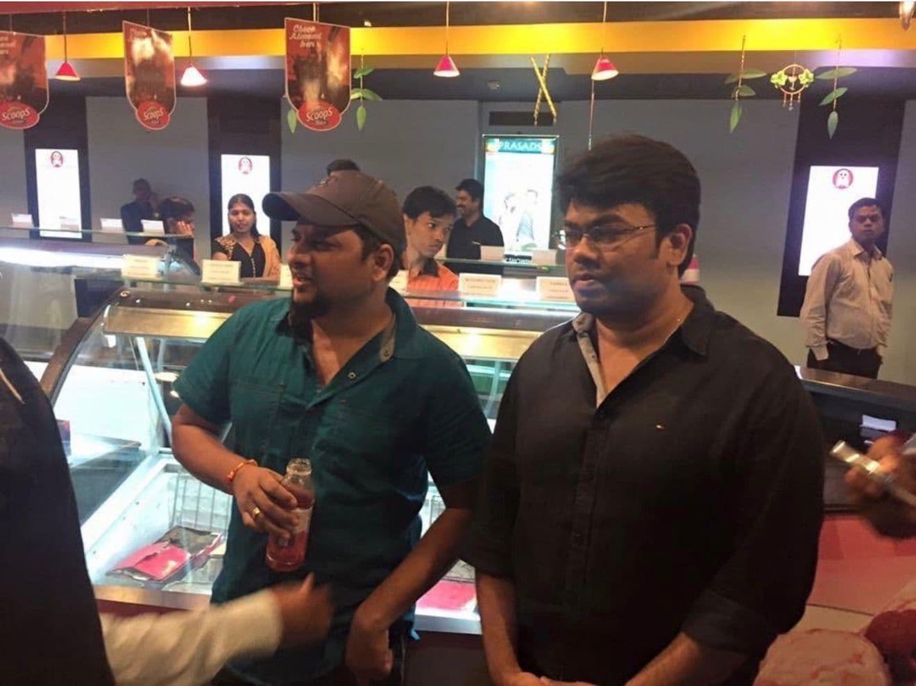 Two men standing together at an ice cream counter